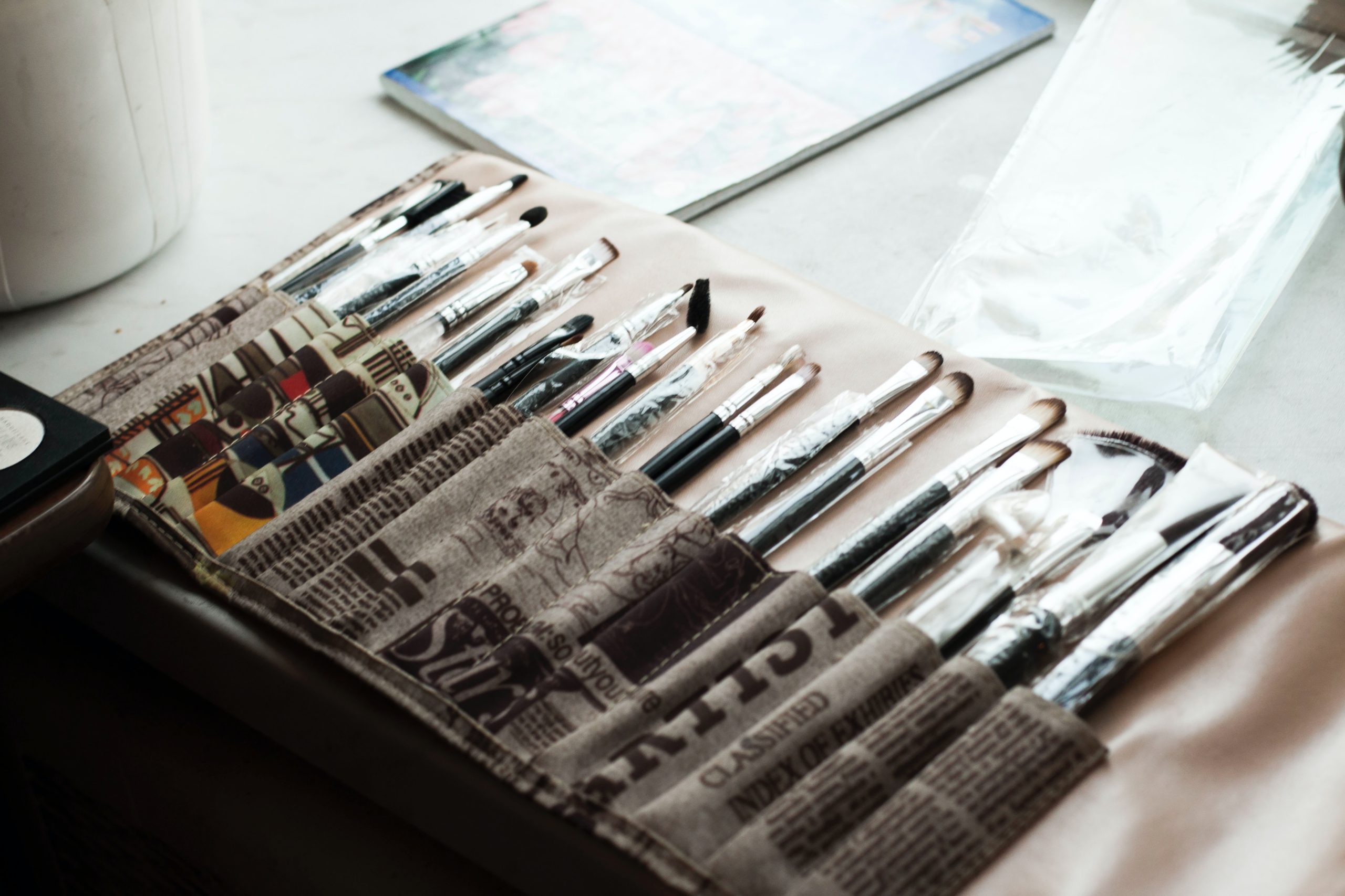 An artist's paintbrushes laid out on a table.