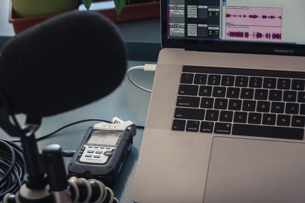 A podcast set up with microphone and computer.