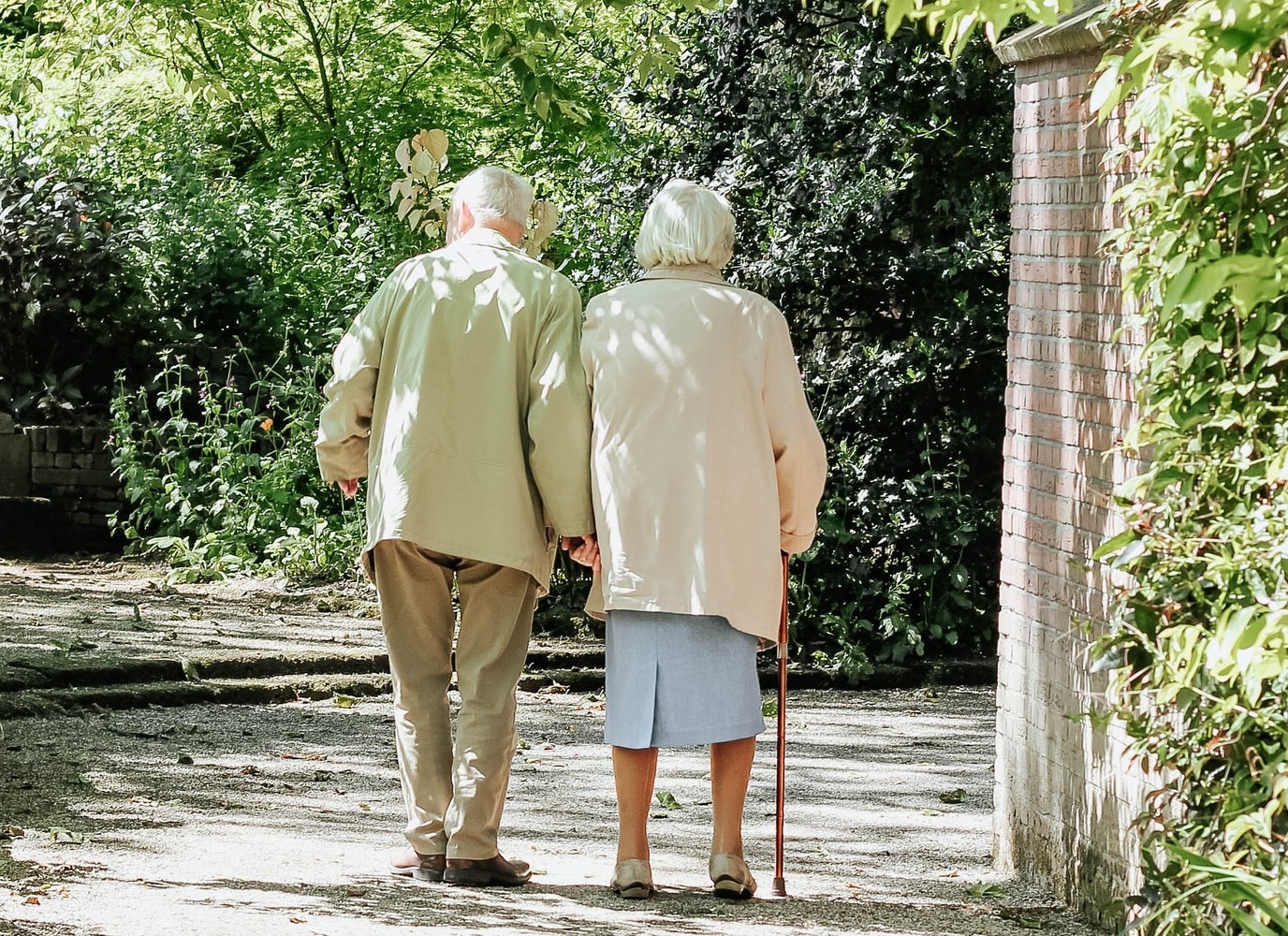 A senior couple walking down a quiet lane